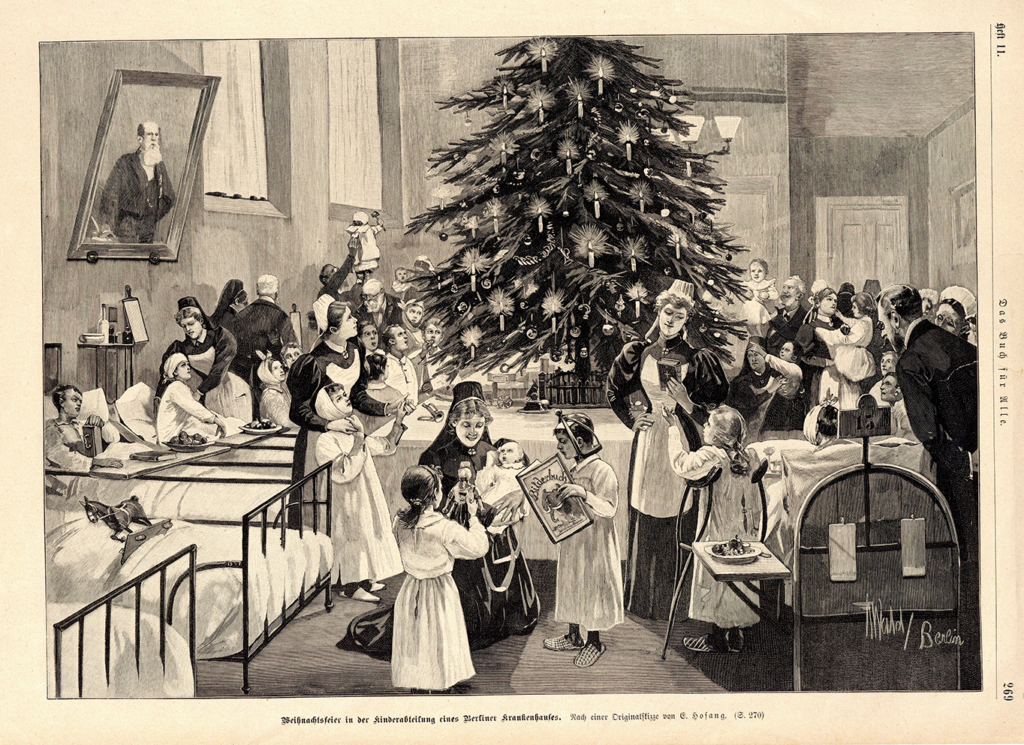 It is a black and white picture. In the centre is a decorated Christmas tree. Lined up to the left of it are many sick beds with children. Nurses in nursing uniforms are looking after the children. The children are wearing light-coloured hospital gowns. There are other people in the room on the right, including men in suits. A large painting of a man can be seen on the left wall above the beds.
